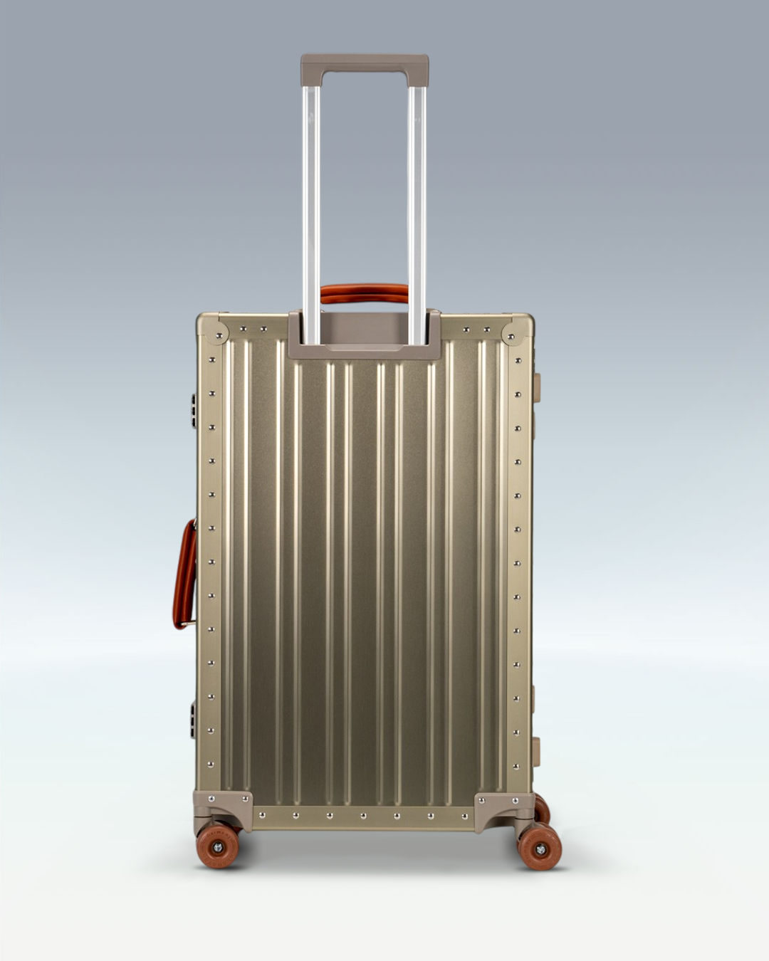 Portar Lucent aluminum checked luggage in Champagne Gold, back view with the telescoping handle extended