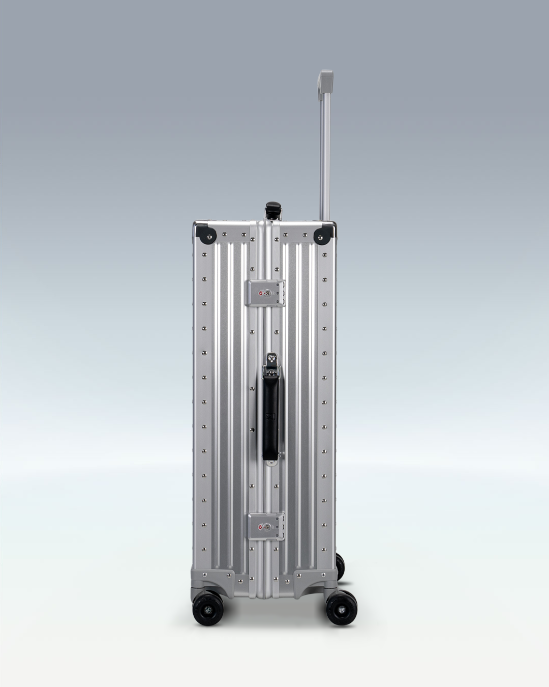 Portar Lucent aluminum checked luggage in Lunar Silver, side view showing the TSA-approved combination locks