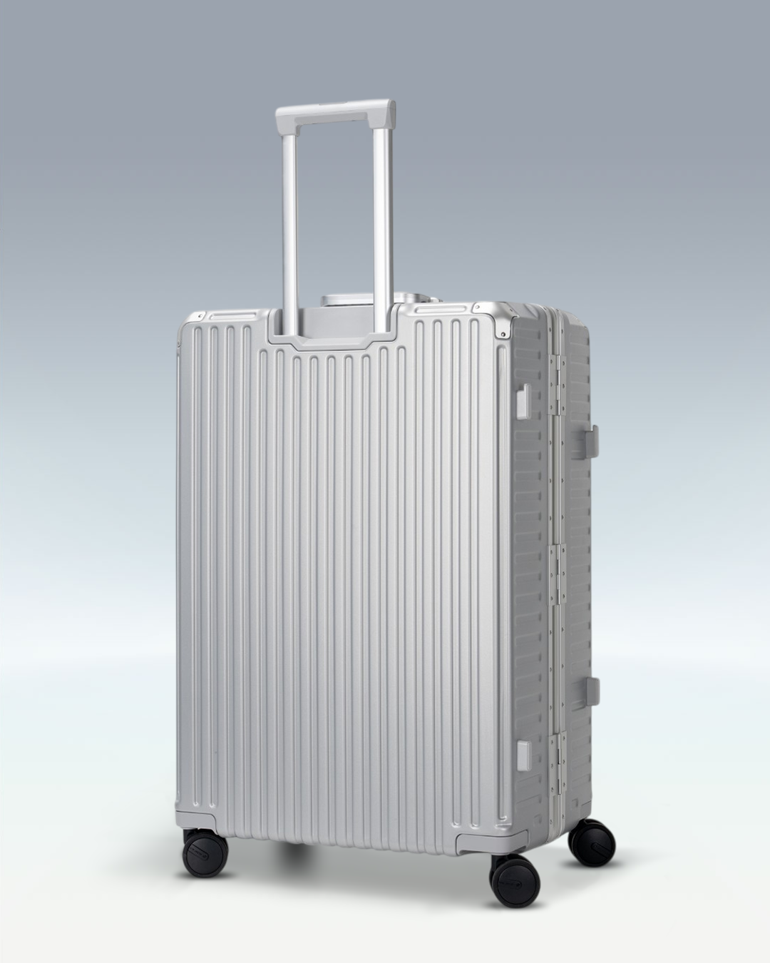 Portar Valence EdgeFrame checked luggage in Lunar Silver, angled side view with the telescoping handle extended