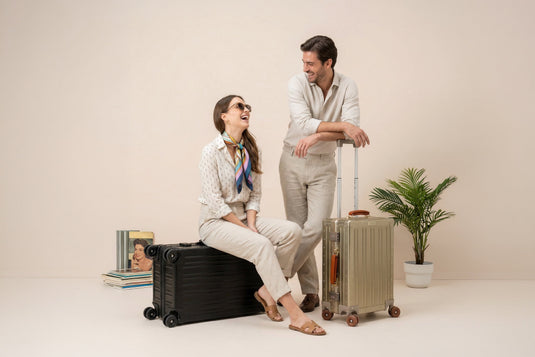 Women sitting next to a Lucent Aluminum Jet Black Suitcase-1