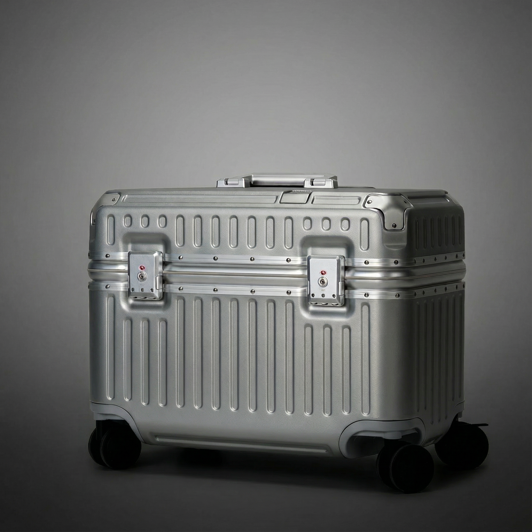 Silver suitcase on a gray background