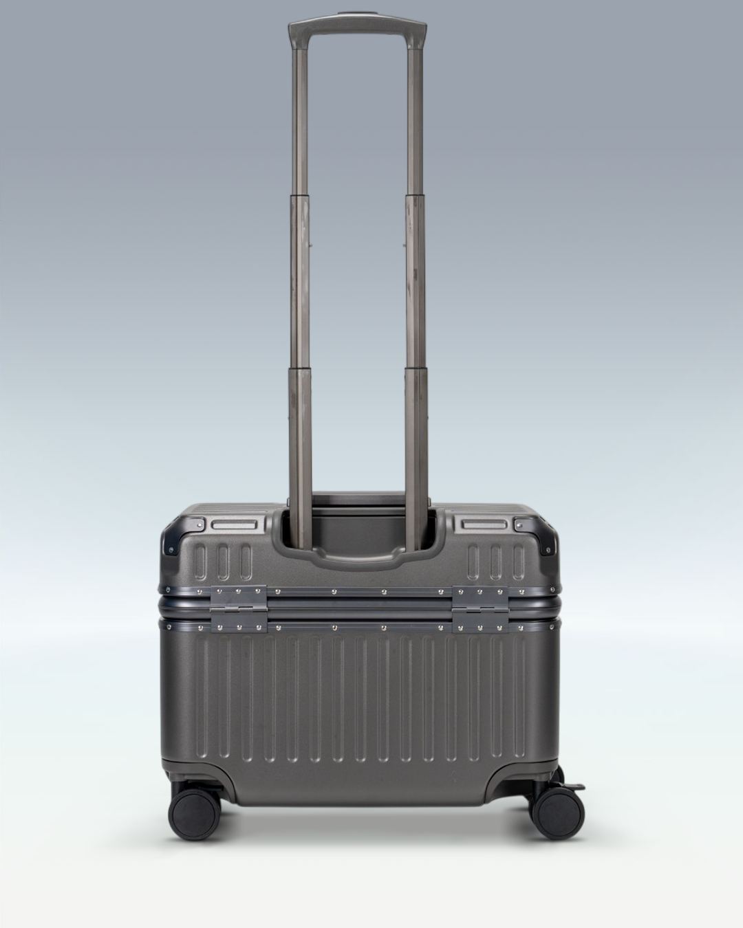 Portar Concord EdgeFrame pilot carry-on luggage in Dark Gull Gray, back view with the telescoping handle extended