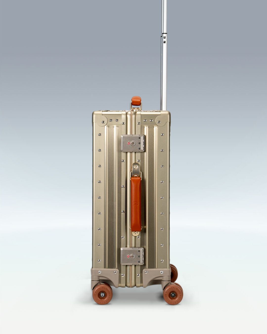 Portar Lucent aluminum carry-on luggage in Champagne Gold, side view showing the TSA-approved combination locks