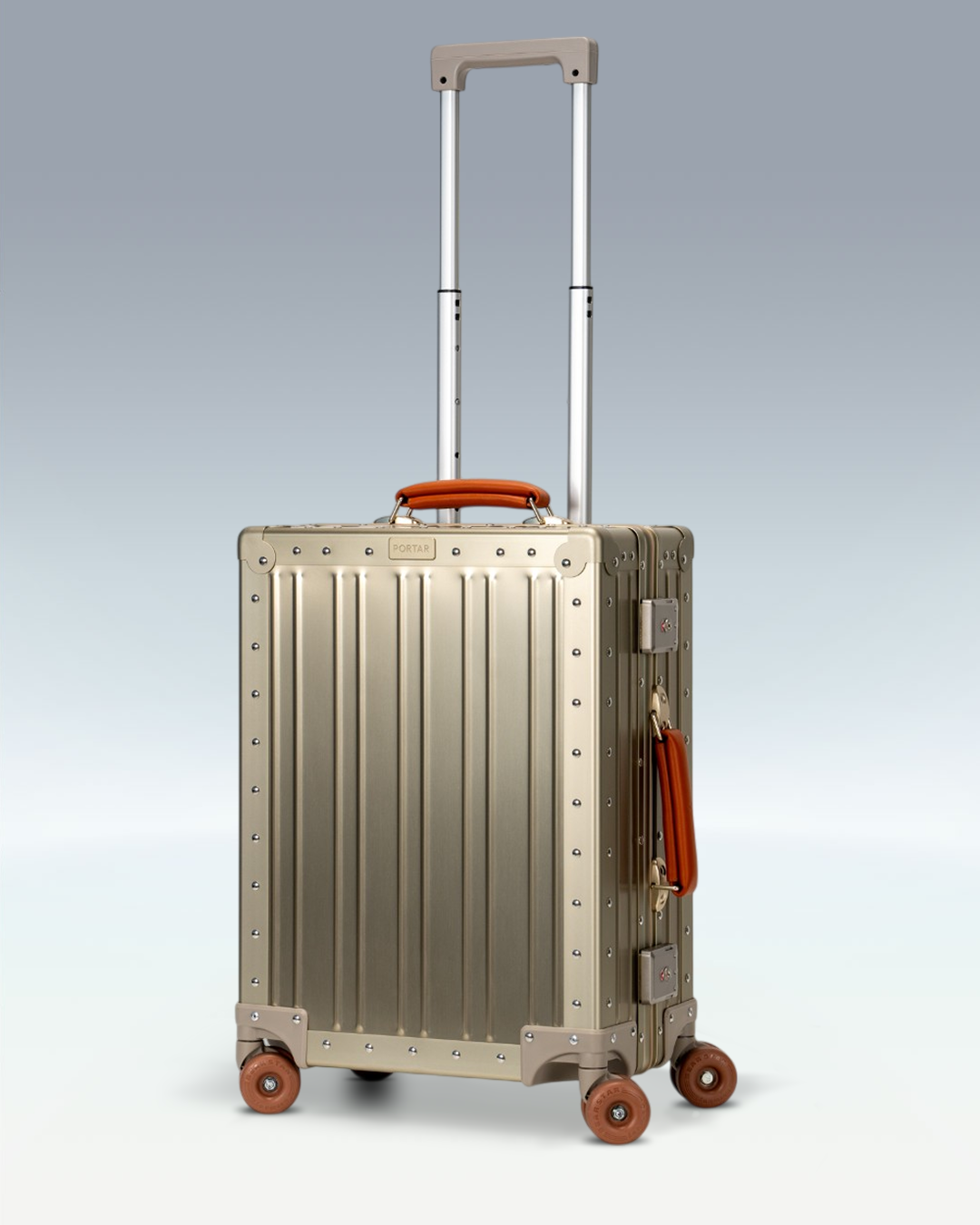 Portar Lucent aluminum carry-on luggage in Champagne Gold, three-quarter view with the telescoping handle extended