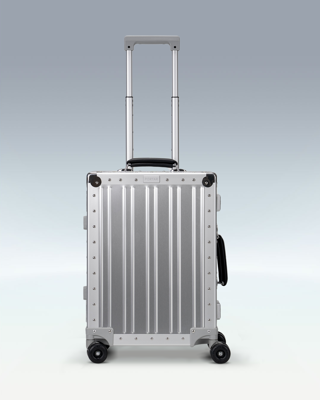 Portar Lucent aluminum carry-on luggage in Lunar Silver, front view with the telescoping handle extended