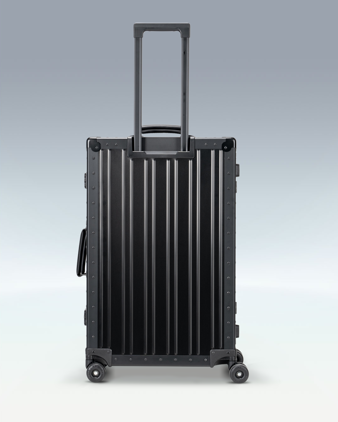 Portar Lucent aluminum checked luggage in Jet Black, back view with the telescoping handle extended