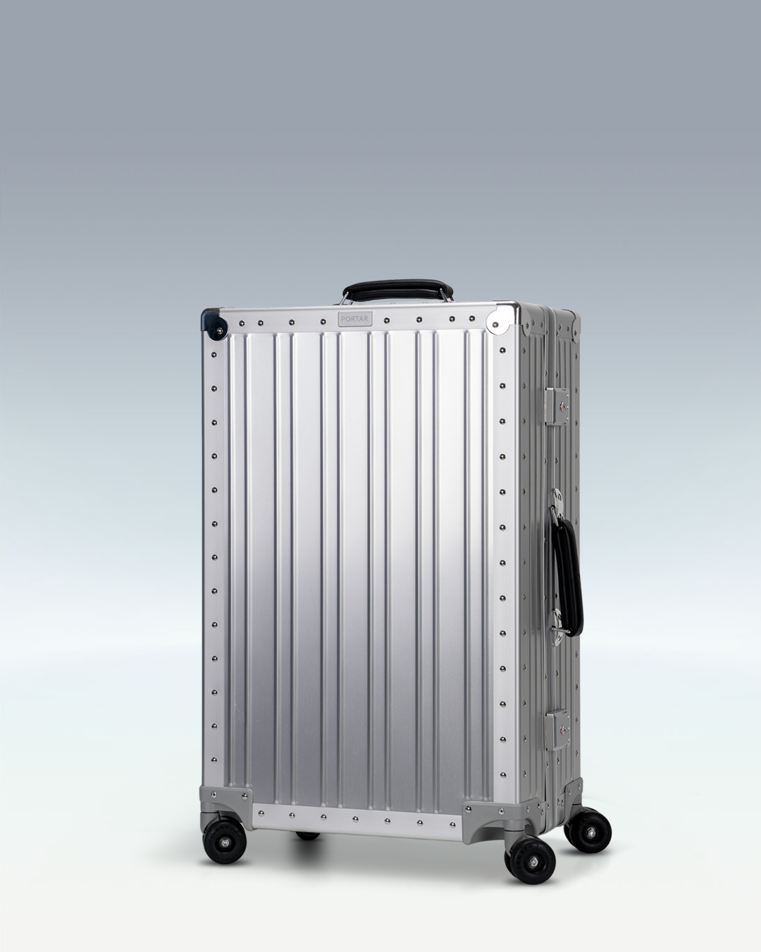 Portar Lucent aluminum checked luggage in Lunar Silver, three-quarter front view
