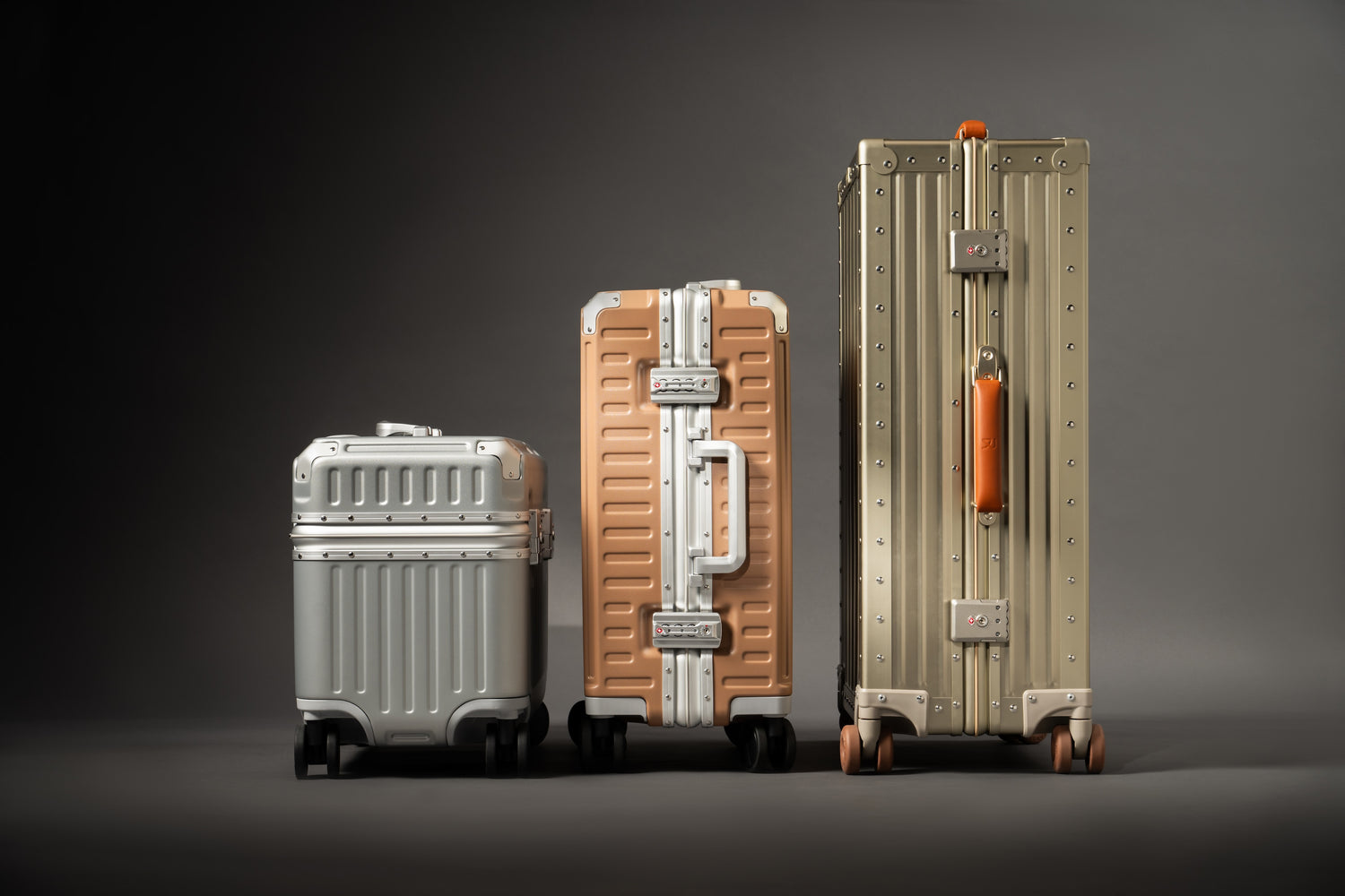 Three Portar suitcases of different sizes on a dark background