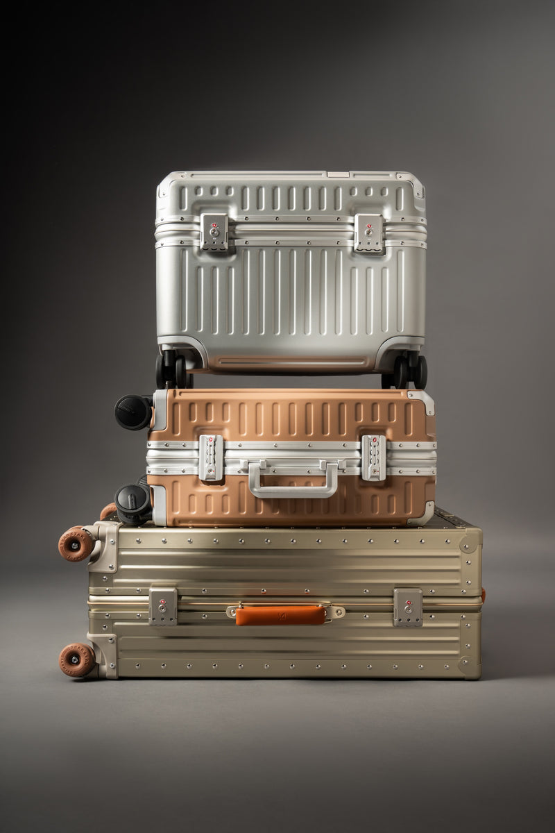 Three Portar stacked suitcases of different sizes on a gray background