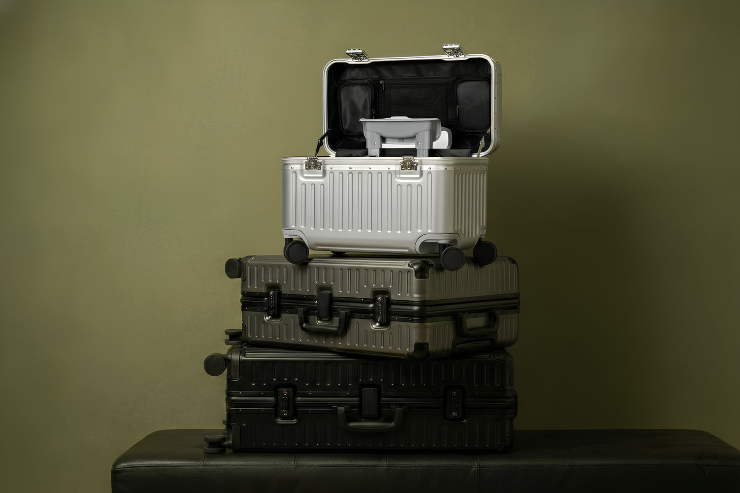 Stack of suitcases with a green background