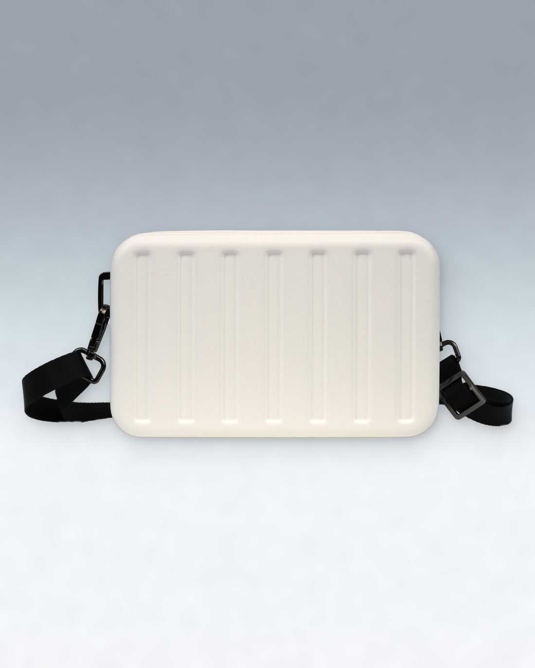 A Cloud Dancer White Portar rectangular crossbody bag with a ribbed front panel and a black adjustable strap, shown against a light gray gradient background.