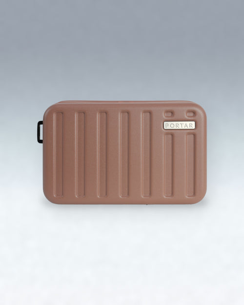 A brown PORTAR crossbody bag with a ribbed design and a small black carrying handle, shown on a light gray gradient background.