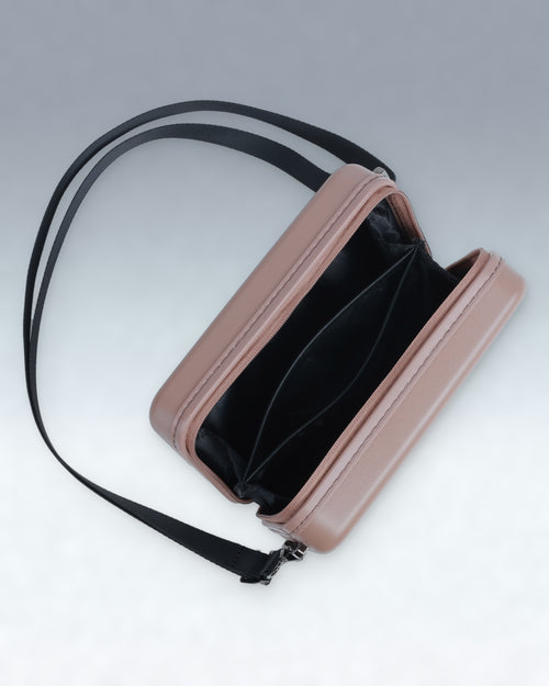 A rectangular shoulder Portar crossbody bag in a mocha mousse brown color with a black interior and a black adjustable strap, shown open against a light gray background.
