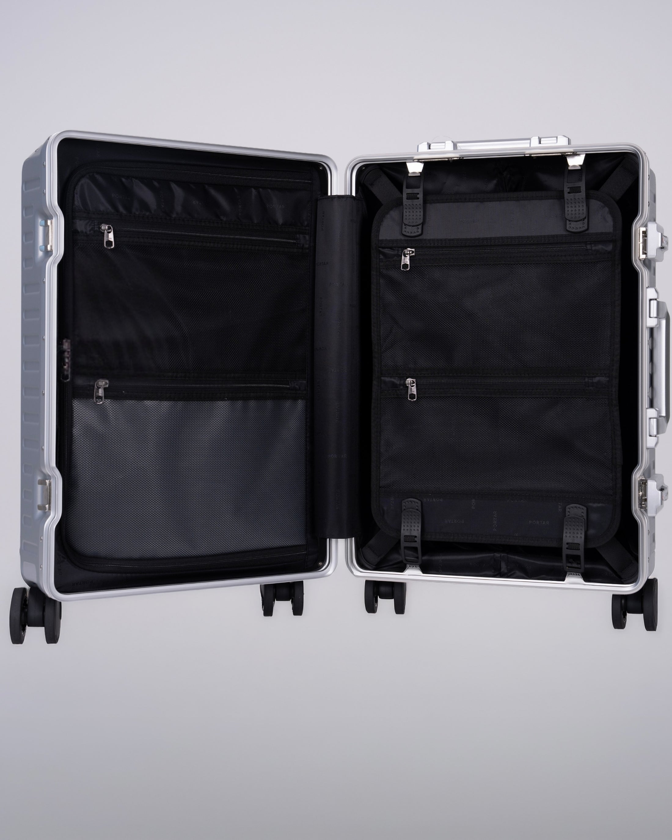 Portar polycarbonate shell with aluminum EdgeFrame suitcase interior details with black interior on a light gray background