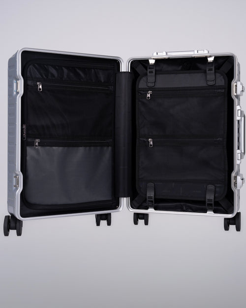 Portar polycarbonate shell with aluminum EdgeFrame suitcase interior details with black interior on a light gray background