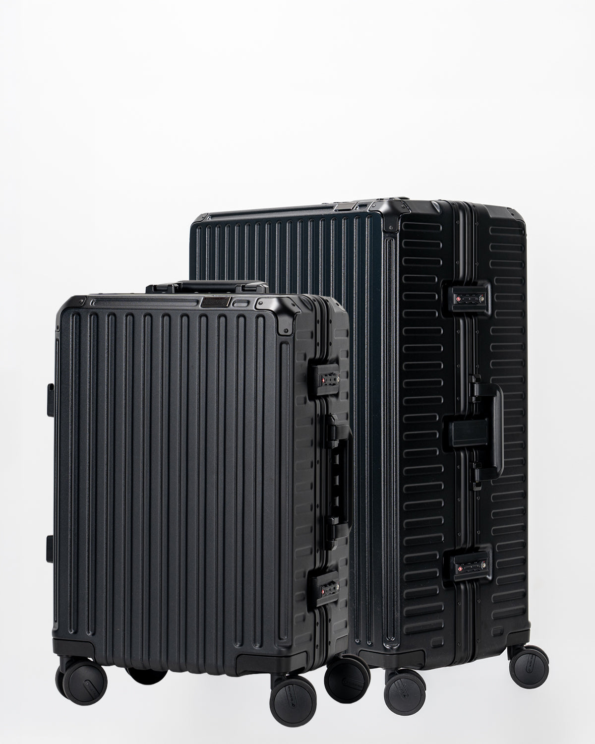 Two Portar Jet Black suitcases with black handles bundled as a travel set on a light gray background