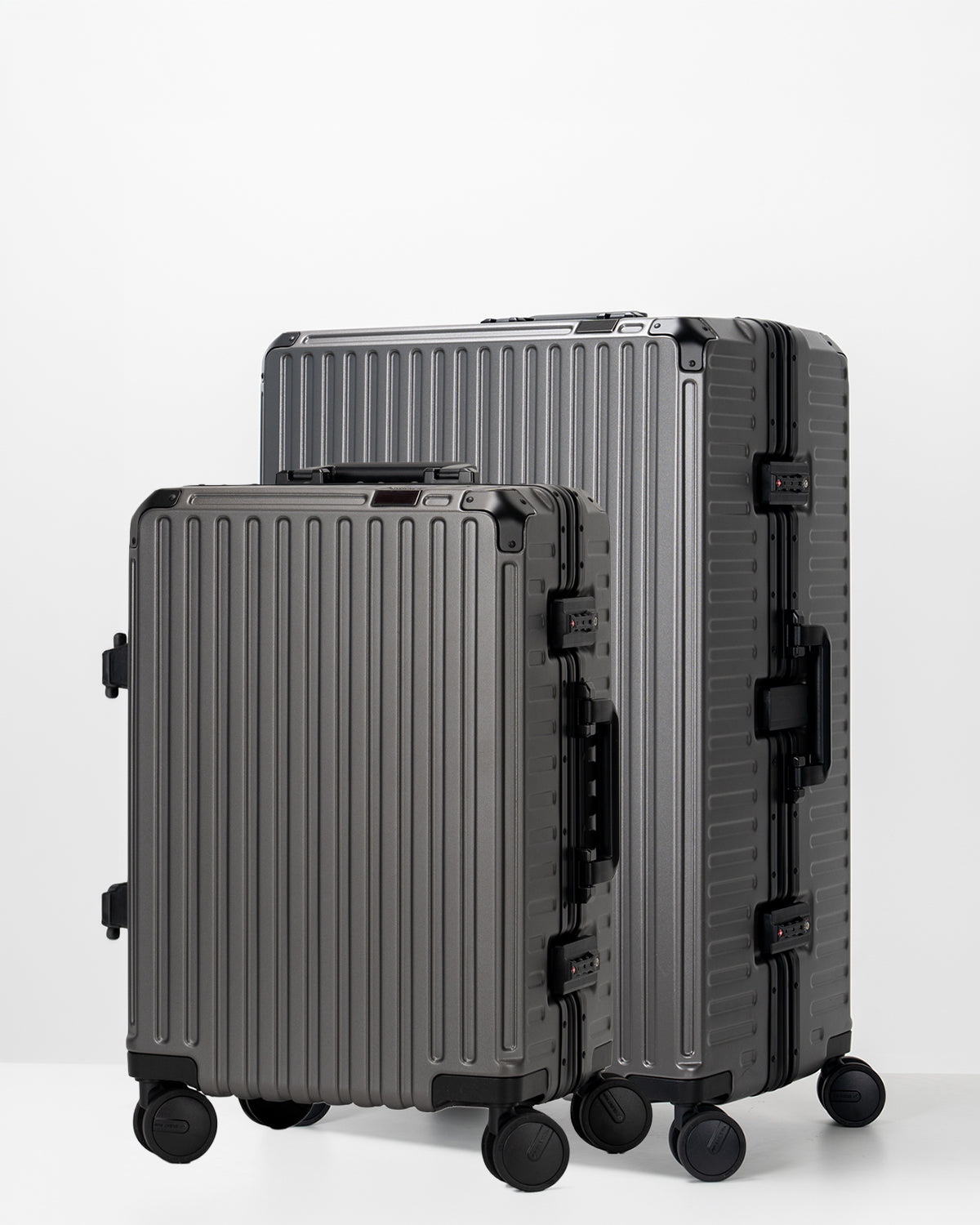 Two Portar Dark Gull Gray suitcases with black handles bundled as a travel set on a light gray background
