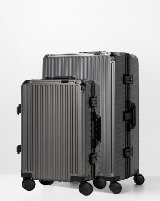 Two Portar Dark Gull Gray suitcases with black handles bundled as a travel set on a light gray background