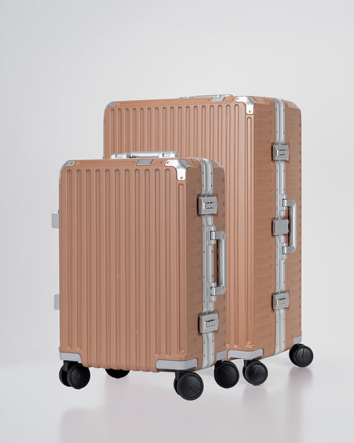 Two Portar Mocha Mousse brown suitcases with silver handles bundled as a travel set on a light gray background
