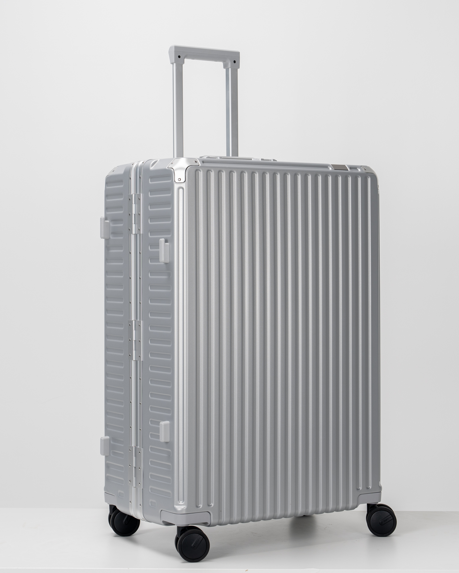 Valence Lunar Silver Polycarbonate Shell with Aluminum EdgeFrame Check-In Suitcase Side Angle View by Portar