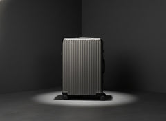 Gray Portar Polycarbonate shell with aluminum Edgeframe suitcase on a dark gray background