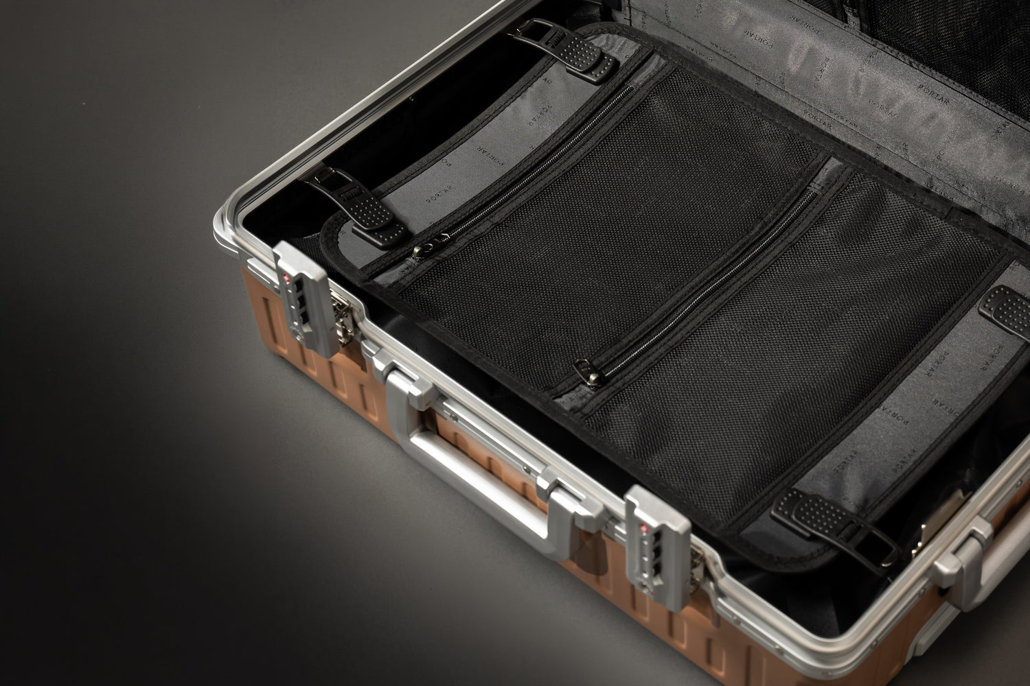 Portar Valence Mocha Mousse Brown Open suitcase with brown exterior and black interior on a dark background
